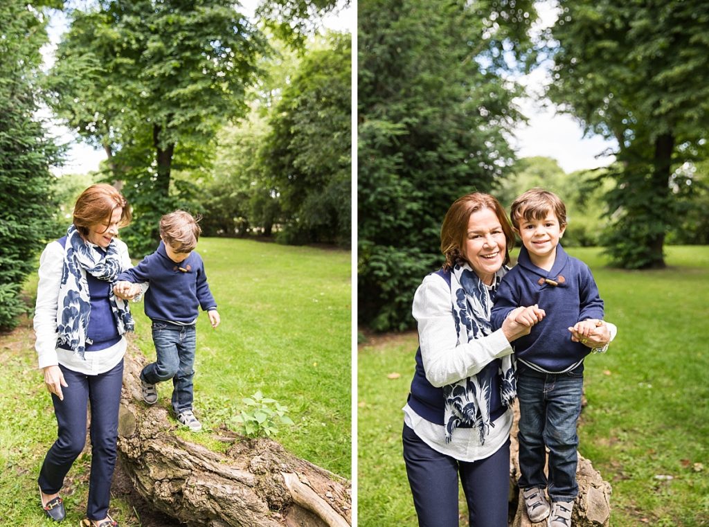 3 year old walking along tree trunk with grandma